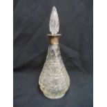 A pear shaped cut glass decanter with hallmarked silver collar and drop stopper, 32cm (h)