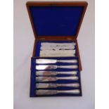 A Victorian mahogany cased set of twelve fish knives with silver blades and handles, London 1881