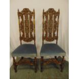 A pair of continental profusely carved and pierced high back upholstered occasional chairs on four
