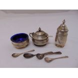 A three piece hallmarked silver condiment set and four condiment spoons