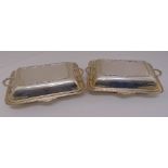 A pair of Mappin and Webb hallmarked silver entee dishes and covers, rounded rectangular with