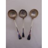 A pair of George III silver hallmarked sauce ladles Old English pattern with scalloped bowls,