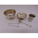 A hallmarked silver sugar bowl, a Victorian silver sifter spoon , a pair of silver tongs, a circular