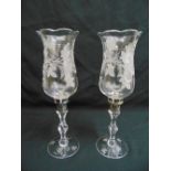 A pair of Stuart crystal storm lanterns on knopped stem and circular spreading bases etched