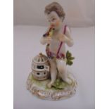 Augustus Rex figurine of a putti with bird and birdcage, marks to the base, 13.5cm (h)