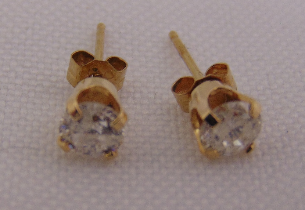 A pair of yellow gold and diamond stud earrings, tested 14ct