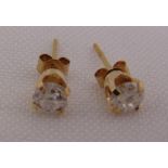 A pair of yellow gold and diamond stud earrings, tested 14ct
