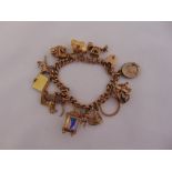 9ct yellow gold charm bracelet with eleven 9ct gold charms and two gold plated charms, approx