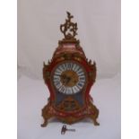 A continental mantle clock, shaped rectangular, the enamel dial with Roman numerals, the gilded