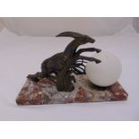 A bronze Art Deco table lamp of globular form with leaping gazelle on a rectangular marble base,