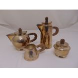 A four piece silver plated Art Deco tea set with wooden handles and finials to hinged covers