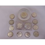 A quantity of USA coins to include 1881 dollar, ten half dollars, a dollar 1882 set in a paperweight