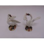 A pair of 19th century Meissen swan figurines 2212 and 2214, marks to the bases, one small chip to