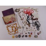 A quantity of costume jewellery to include necklaces, brooches and pendants