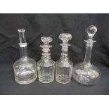 Four cut glass decanters of various form and shape all with drop stoppers
