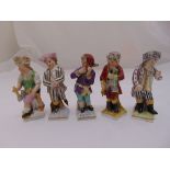 Five German figurines of children in various poses on raised square base