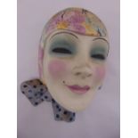 An Art Deco ceramic wall plaque in the form of a ladies face, 28cm (h)