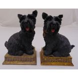 A pair of composition bookends in the form of Scotty dogs on raised rectangular bases, 18cm (h)