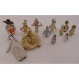 Twelve continental porcelain half dolls and pin cushions of varying size