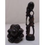 A dense wood oriental figurine of a crying Buddha, 12cm (h) and an African figurine carved with