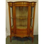 An Edwardian mahogany and satinwood glazed display case shaped rectangular with bow front, decorated
