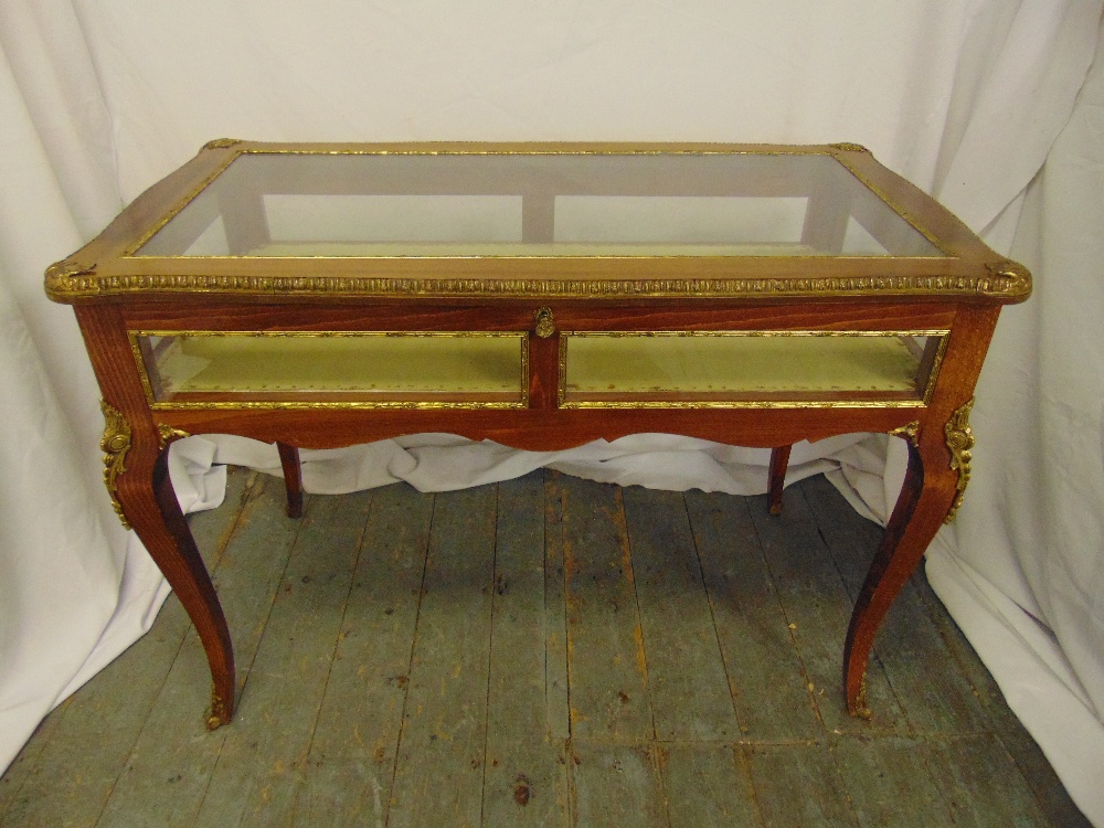 A Louis XVI style rectangular mahogany and gilt metal bijouterie display table with glazed sides