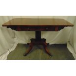 A Regency drop leaf mahogany Pembroke table on quadriform base with brass paw feet, 75 x 120.5