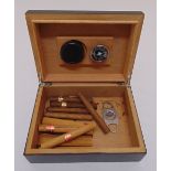 A rectangular humidor with cedar wood interior to include cigars and a metal cigar cutter