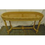 A French oval bergere stool with hand painted detail on four tapering fluted legs, 51 x 90 x 38cm