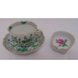 A Meissen cabinet cup and saucer decorated with flowers, marks to the base and a small dish
