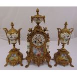 A French gilt metal and porcelain mantle clock with matching vase form garnitures with gilded