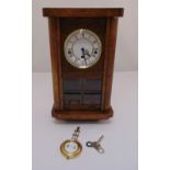 An oak cased rectangular mantle clock, white enamel dial, Roman numerals, glazed front to include