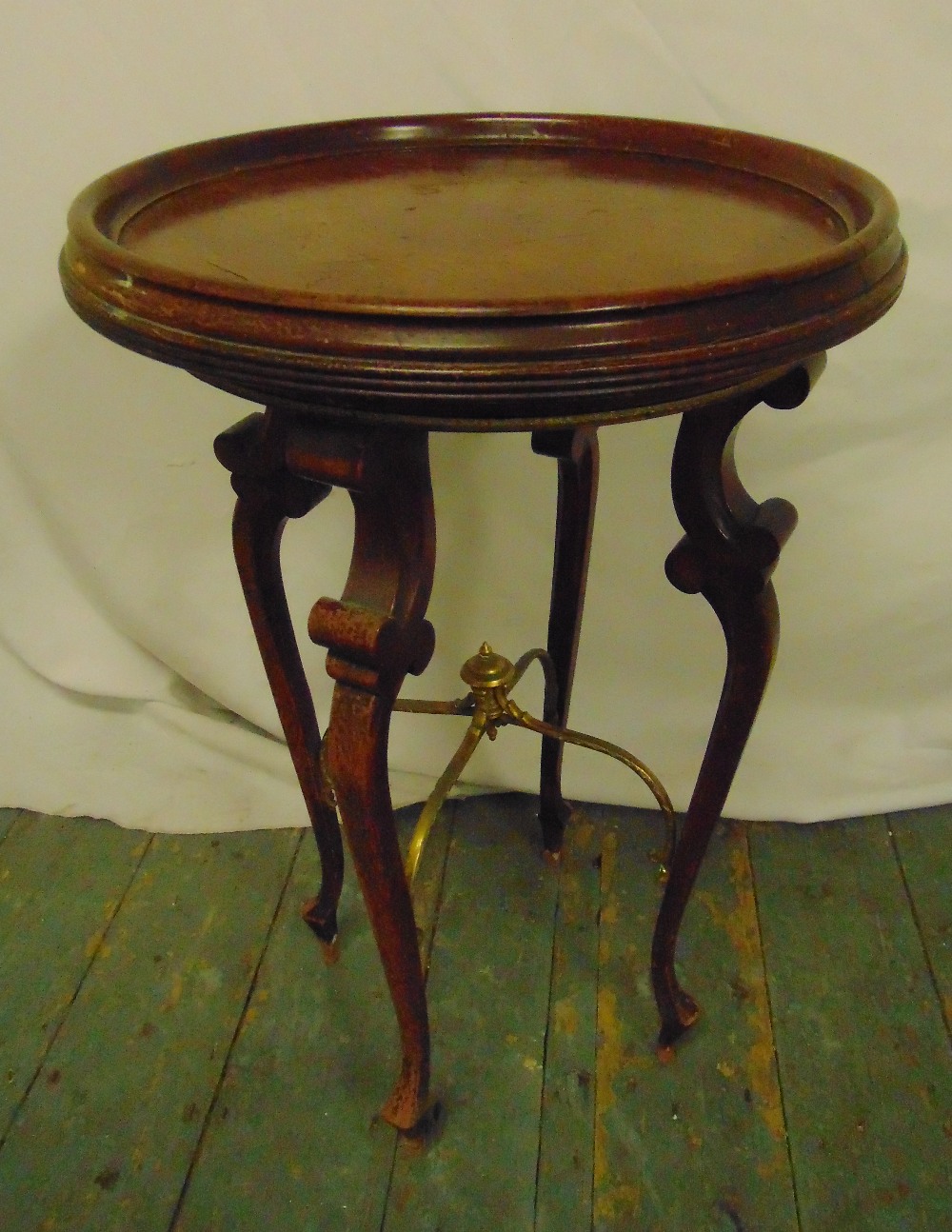 A mahogany circular side table on four cabriole legs, 61 x 40cm