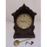 A Victorian mahogany chiming bracket clock, shaped rectangular with leaf and scroll carved swags,