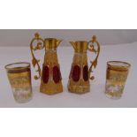 Two continental miniature coloured glass ewers and two matching shot glasses, 10cm (h)