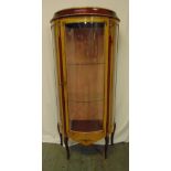 A continental glazed display cabinet of cylindrical form with gilt metal mounts, hinged door on four