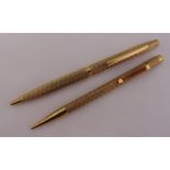 A hallmarked 9ct gold ball point pen and a matching propelling pencil