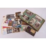 A quantity of vintage postcards to include an album, loose cards and first day covers
