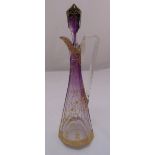 A continental amethyst faceted glass wine ewer with applied gilded decoration, angled handle and