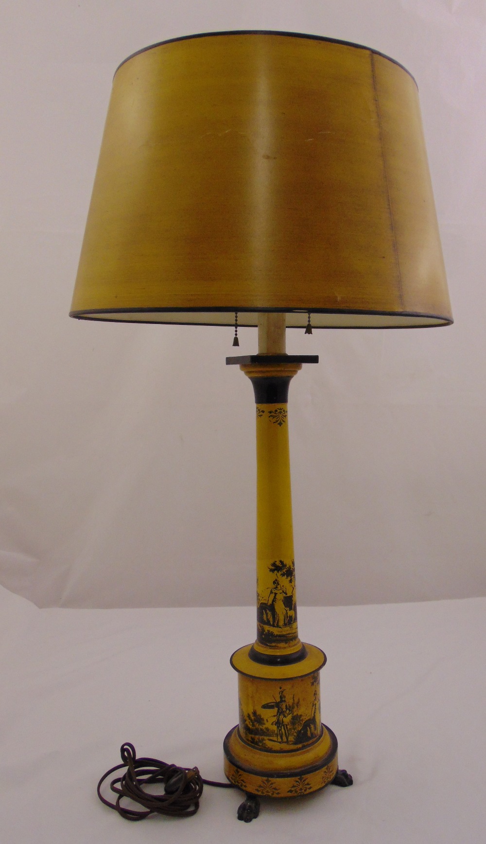 An Italian toile ware yellow lamp base of columnular form on cylindrical base with three paw feet to