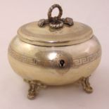 A continental white metal compressed oval box with raised hinged cover with rope finial on four