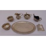 A quantity of white metal to include a miniature tray, milk jug, sugar bowl three salts with glass