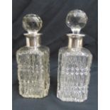 Two hobnail cut crystal decanters with white metal collars and faceted drop stoppers, 24cm (h)