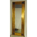 A rectangular Arts and Crafts style gilded framed wall mirror, 145 x 53cm