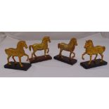 Four bronze figurines of the horses of St Marks on rectangular plinths, 18cm (h)
