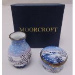 Moorcroft enamel vase decorated with a winter landscape and a matching patch box, both signed to the