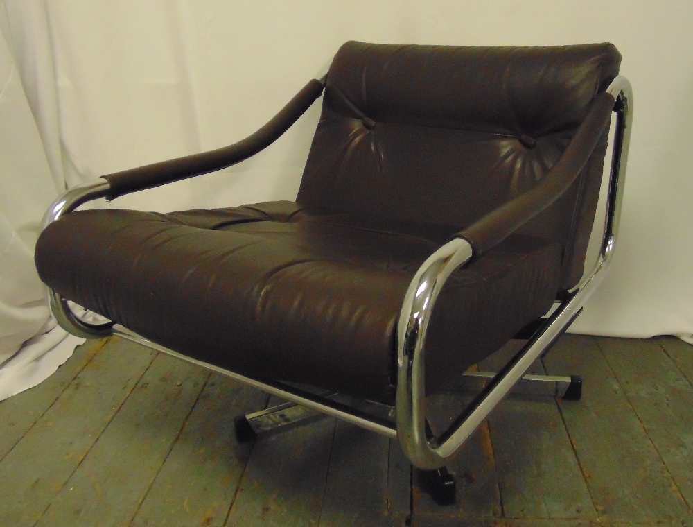 A late 20th century chrome and leather revolving armchair