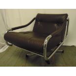 A late 20th century chrome and leather revolving armchair