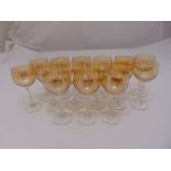 A set of fourteen coloured liqueur glasses with barley twist stems and circular spreading bases
