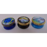 Three Moorcroft enamel pill boxes, signed to the bases